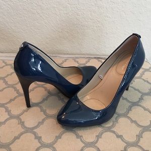 Calvin Klein shiny Navy heel.