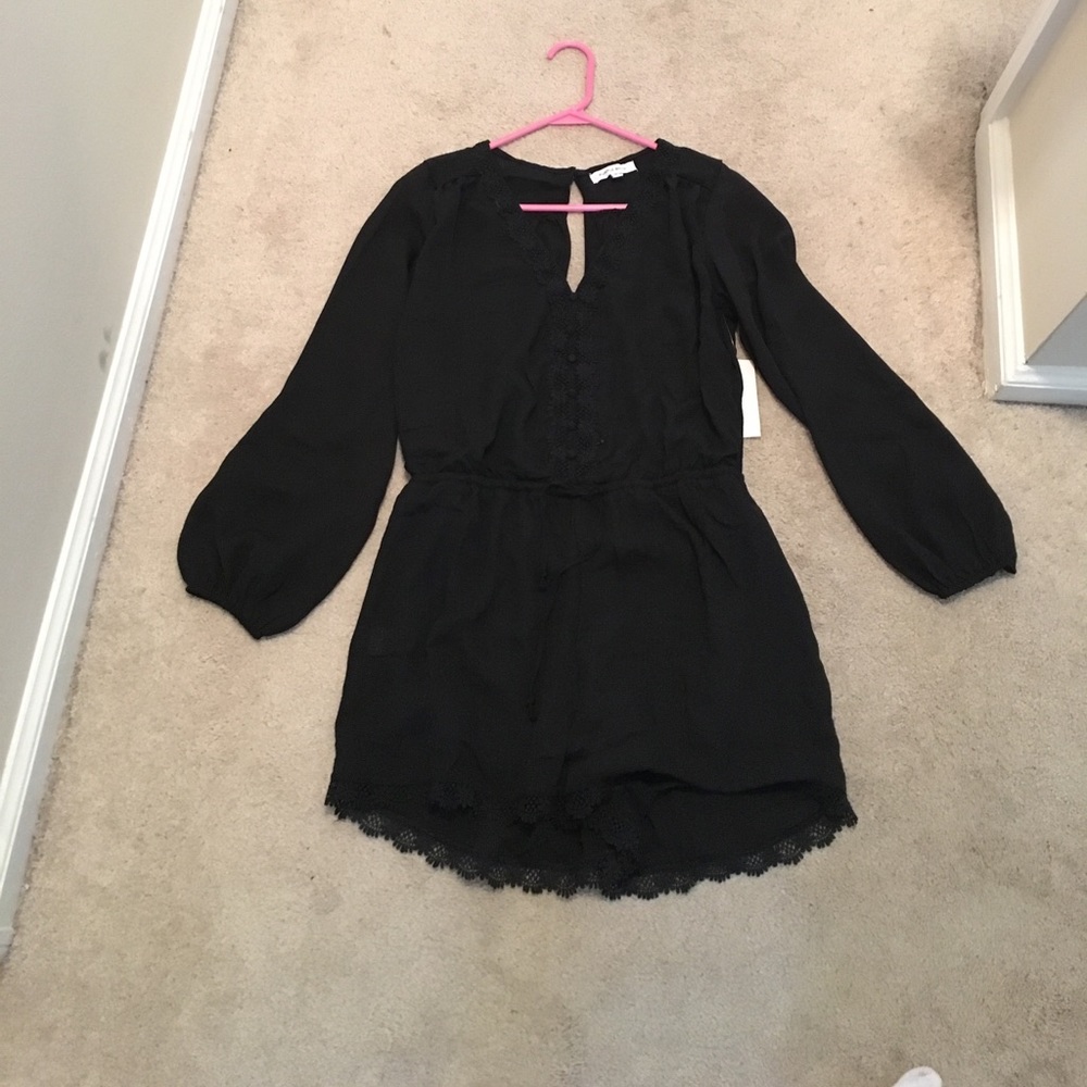 NWT. Black romper with lace detail