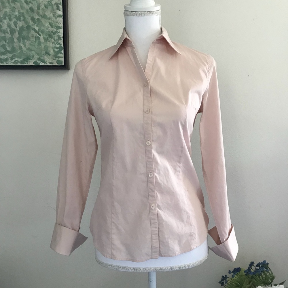 Pink button down shirt.