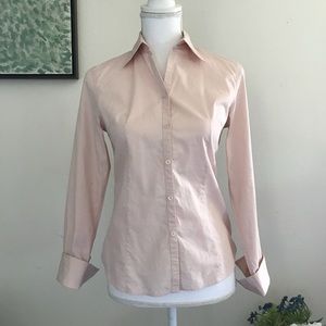 Pink button down shirt.