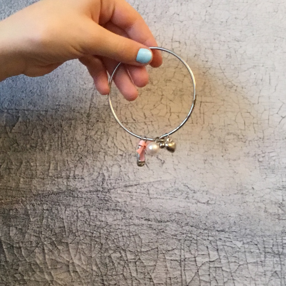 Silver toned metal charm bracelet.