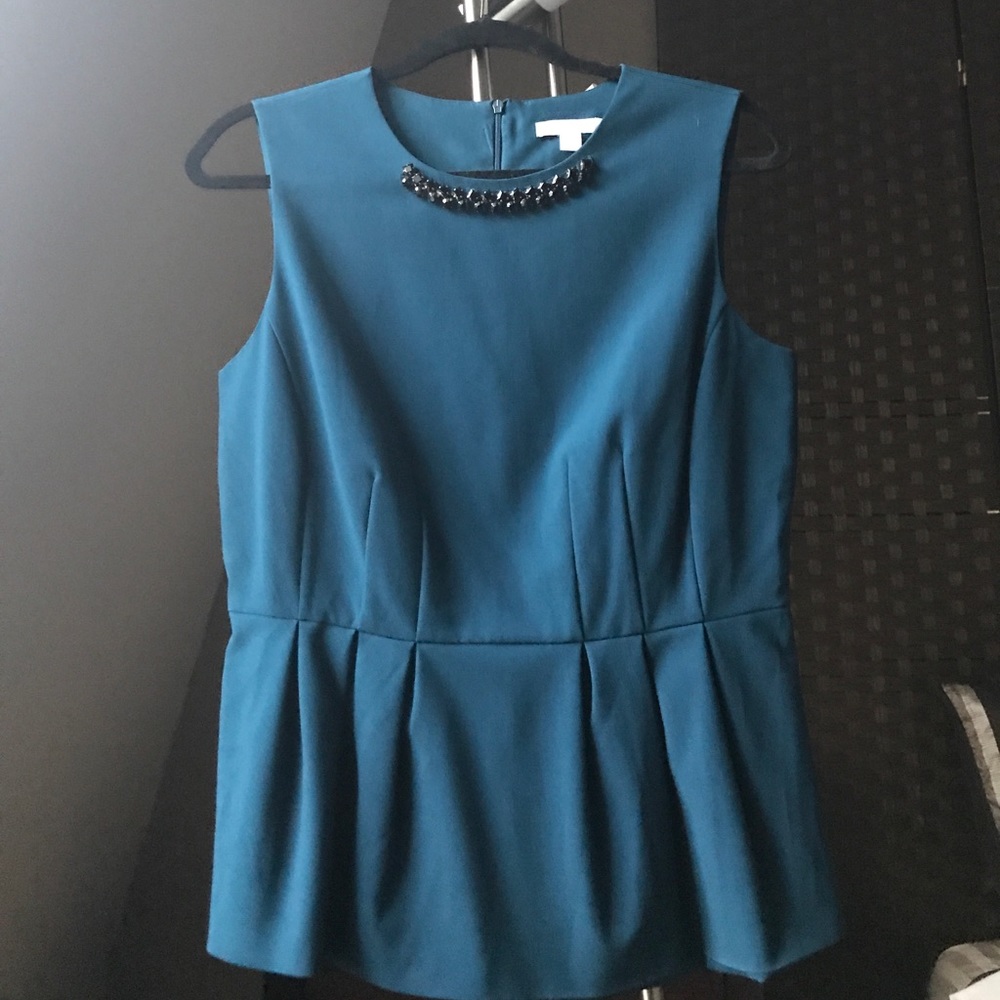 Peplum shell with bejeweled neckline detail