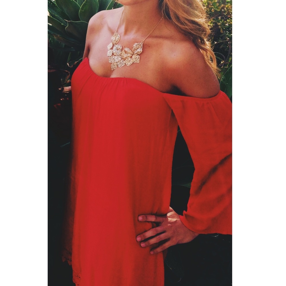 Off the shoulder red dress.