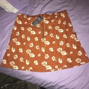 Dark orange skirt, with white flowers