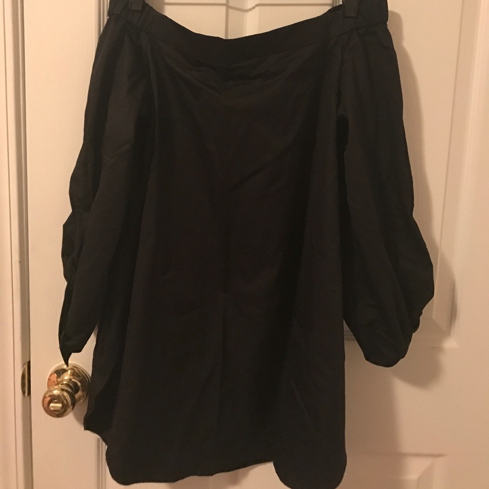A black Tibi off the shoulder shirt