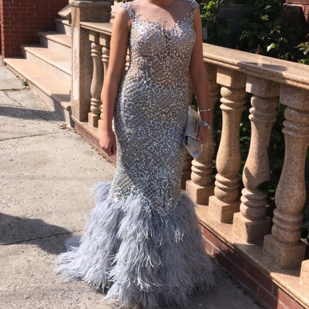 Sleeveless gown with crystals and feathers