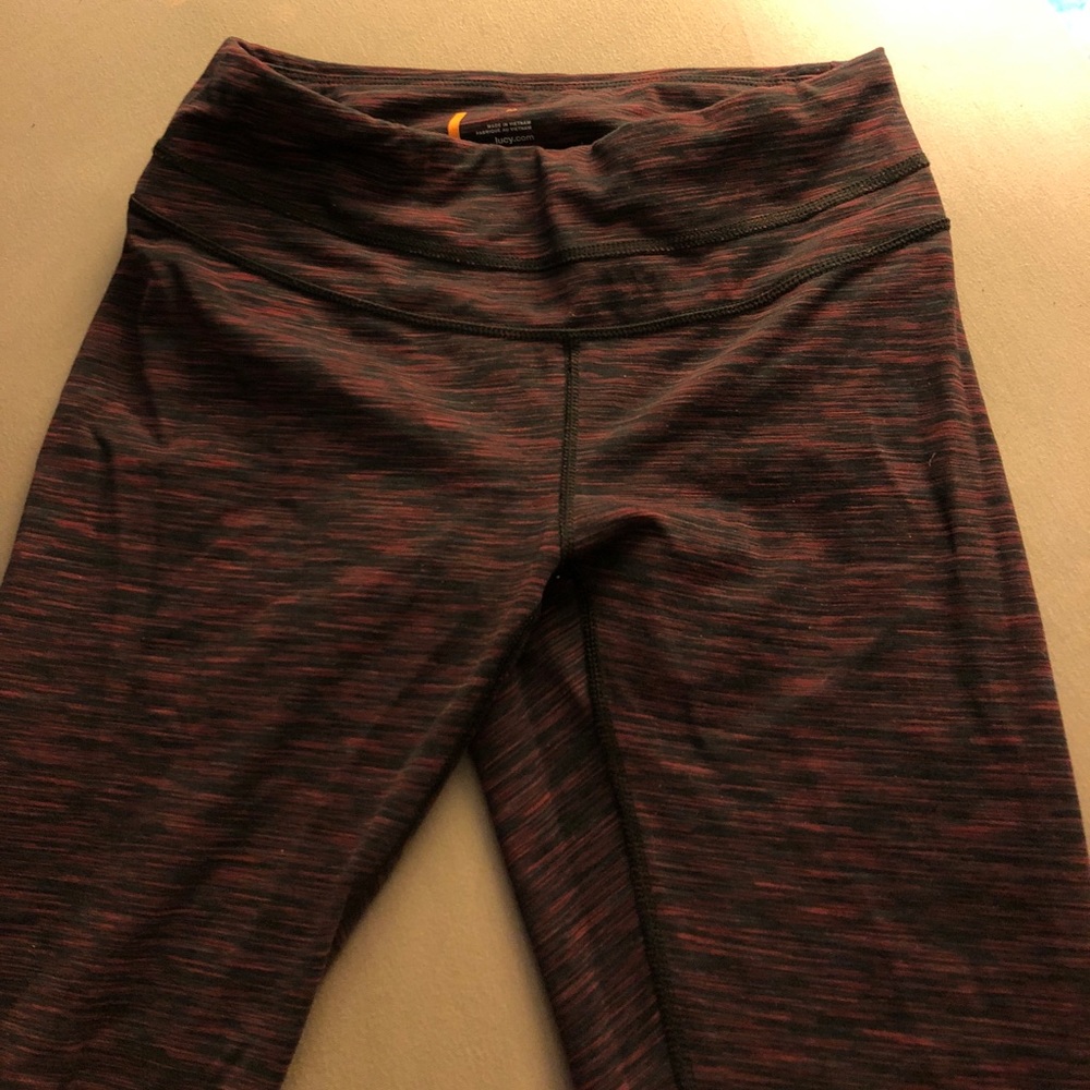 Dark pink/red and black yoga pants.