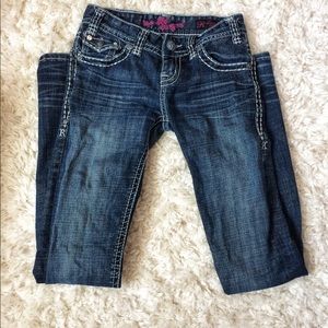 Boot cut jeans with rhinestoned pockets.