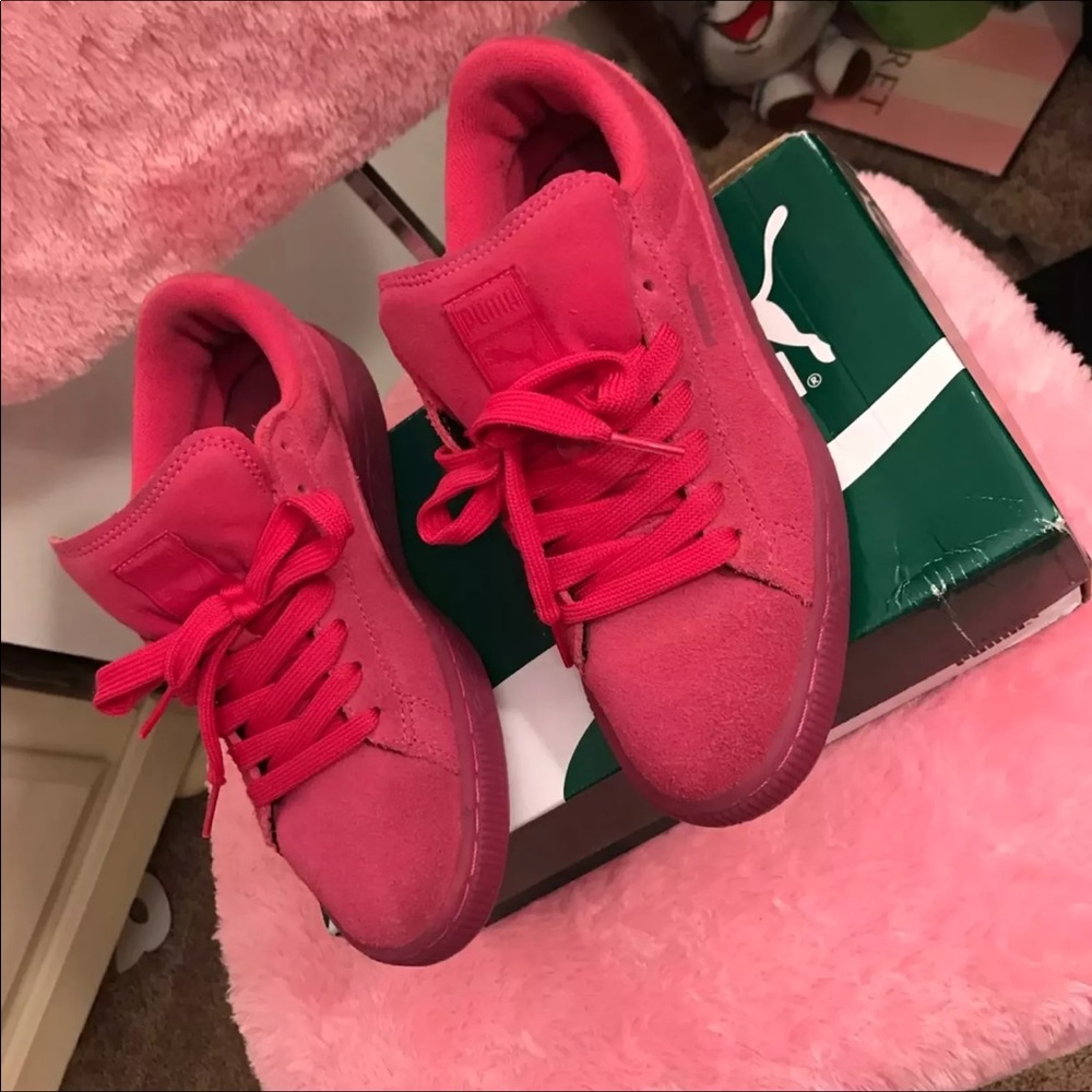 Pink suede pumas