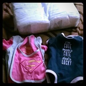 2 newborn sized onesies and some diapers