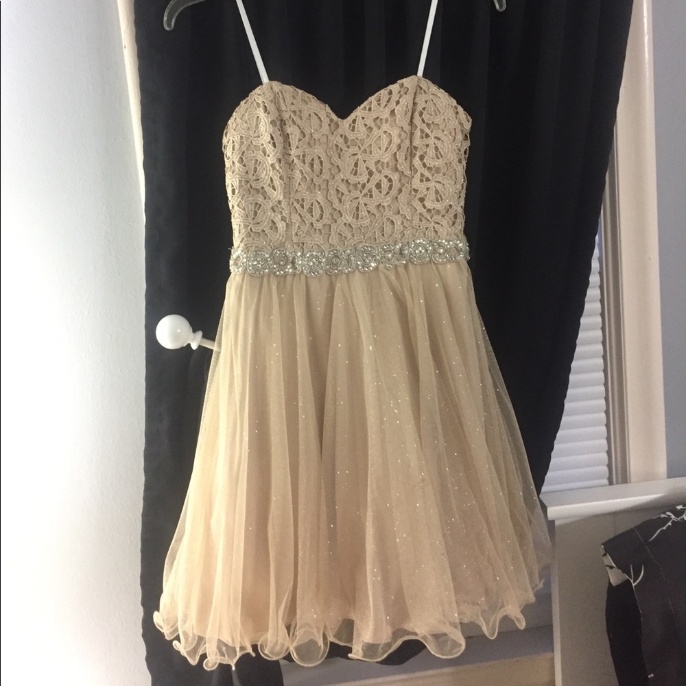 A beige colored strapless dress
