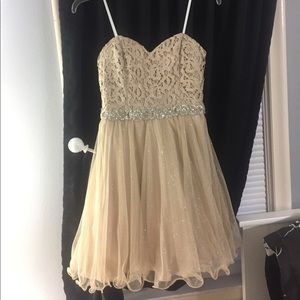 A beige colored strapless dress
