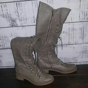 Taupe high top combat boots.