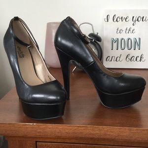 Black high heels with ankle strap. Never worn