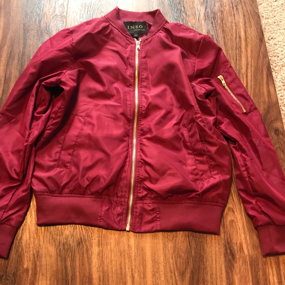 Maroon bomber jacket.
