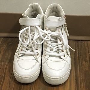 White platform shoes with metal decorations