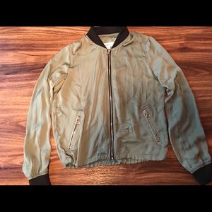 Green in worn bomber jacket