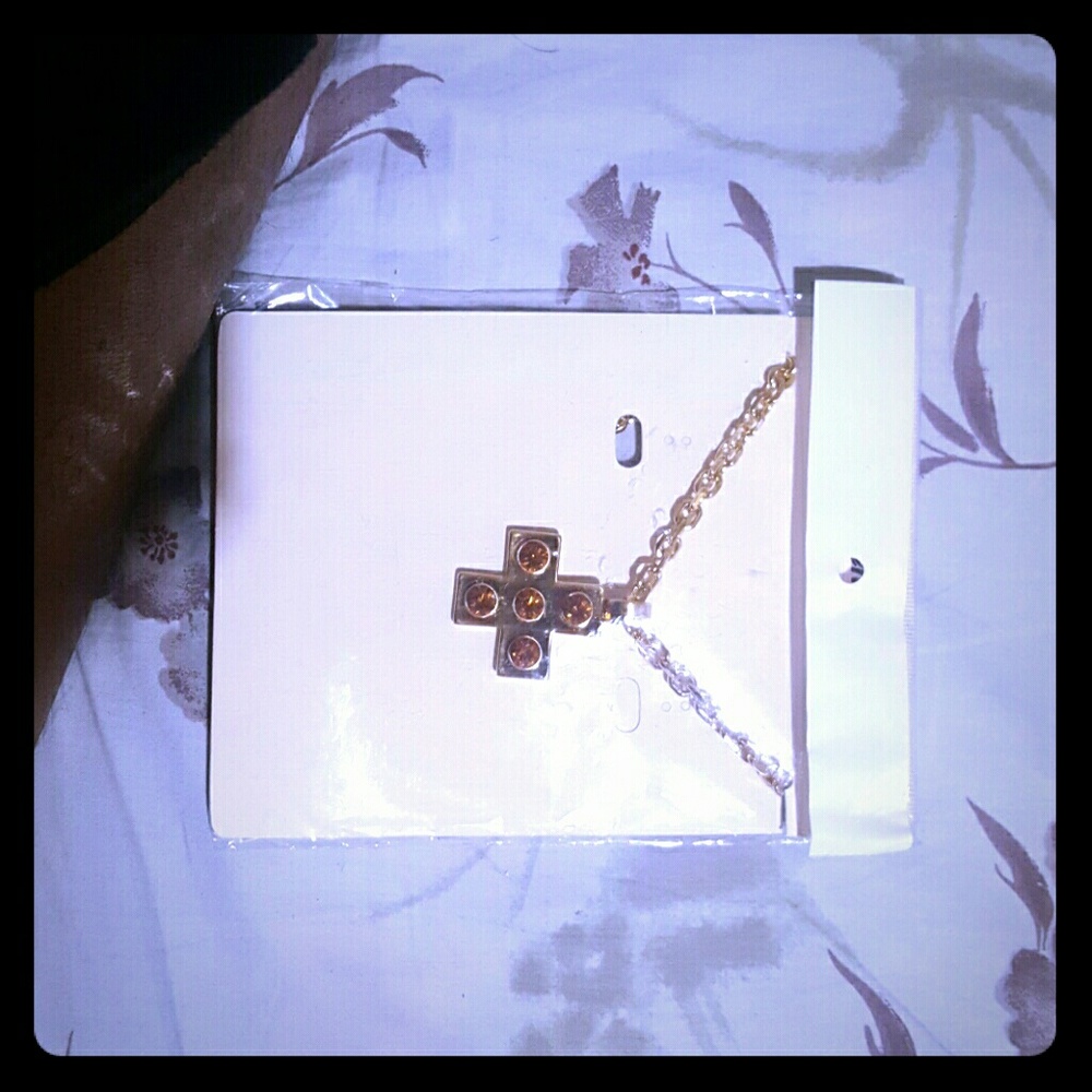 It's a medium size pendant with a long gold chain