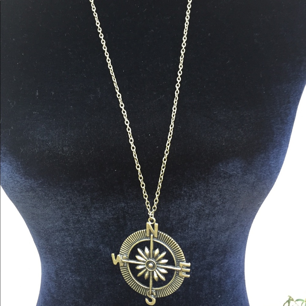 Compass pendant on chain necklace.