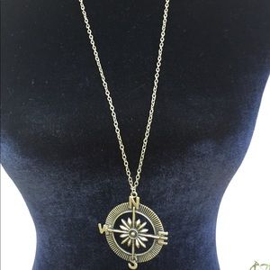 Compass pendant on chain necklace.
