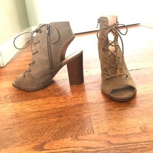 Chunky heel faux suede lace up peep toe booties.