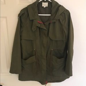 Women's olive green rain jacket.