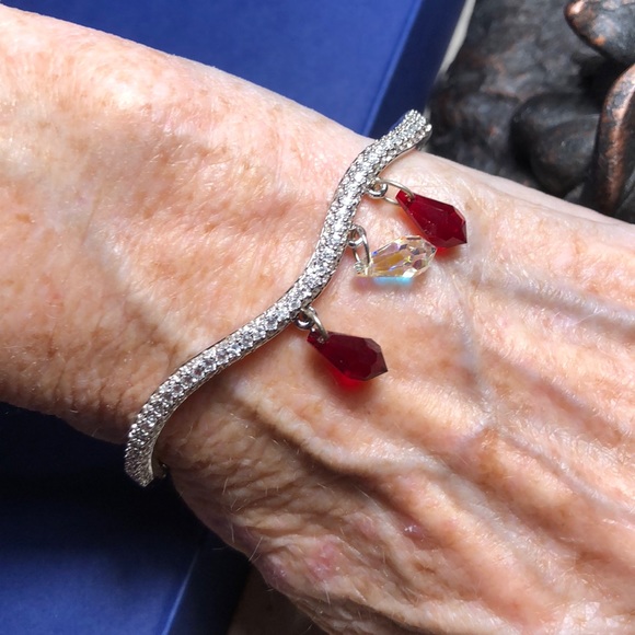 Swarovski Jewelry - Swarovski silver bracelet w/red & crystal pendants