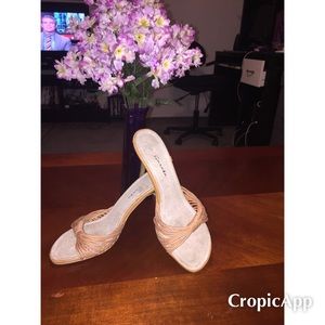 Tan strappy mule like heels.