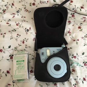 Light blue polaroid camera, black case