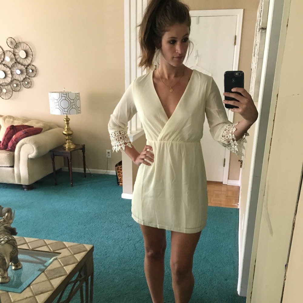 Off white dress with lace at bottom of sleeves