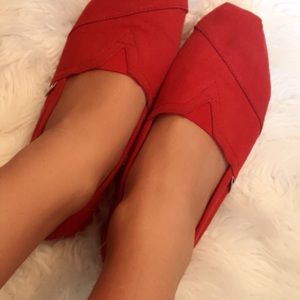Worn toms red slip on shoes