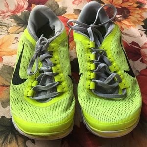 Neon yellow mesh Nike shoes with black swoosh