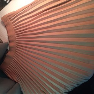 Pleated over knee skirt