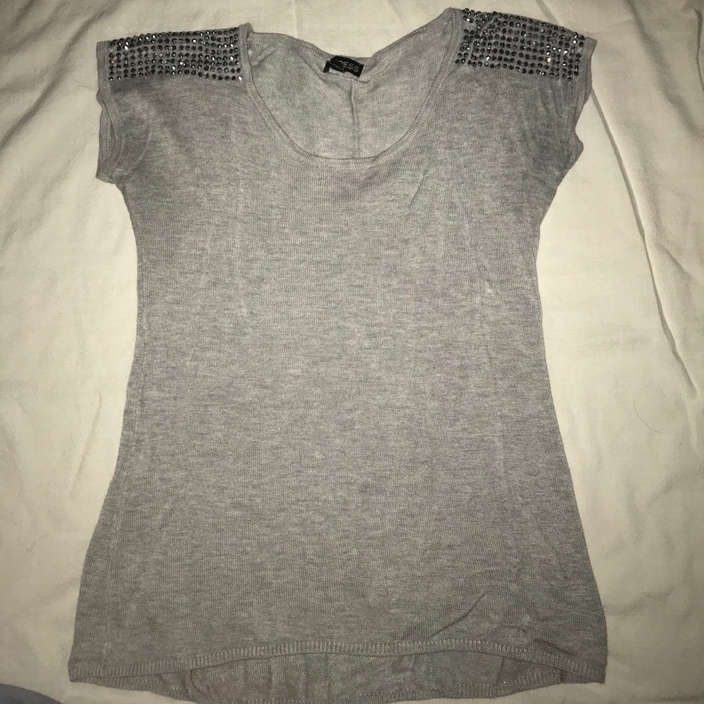 Silver studded shoulder design on light grey shirt