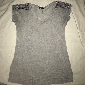 Silver studded shoulder design on light grey shirt