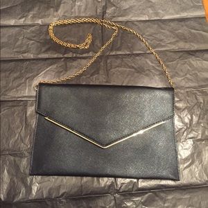 Black clutch with a gold chain