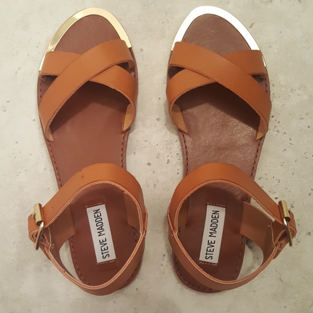 Crossover strap sandals with faux gold hardware.
