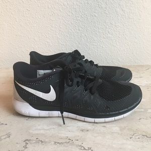 Black “Nike Free 5.0” athletic shoes
