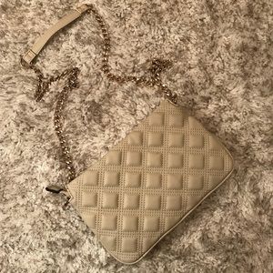 Quilted crossbody bag with gold chain.