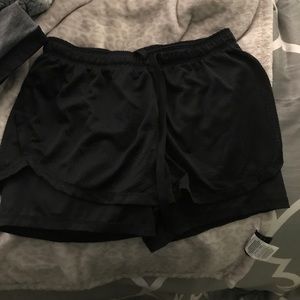 Black Reebok workout shorts with spandex under
