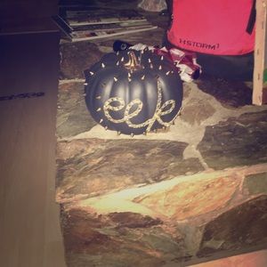 Homemade black pumpkin with gold accents.