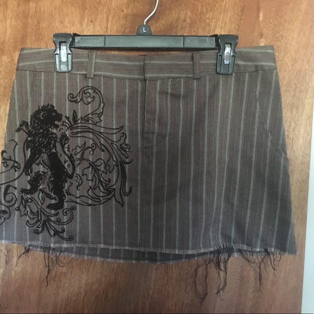 Brown skirt with red pin stripes and felt design.