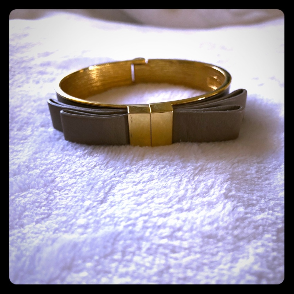 Vince Camuto gold bracelet with leather bow