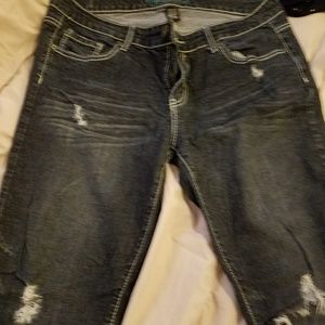 Distressed dark blue jeans