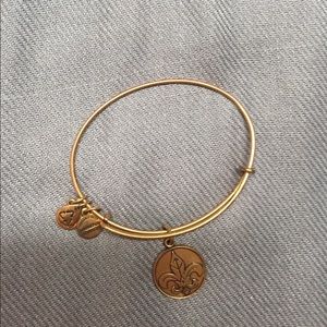 Alex & Ani gold bangle with Fleur de lis charm