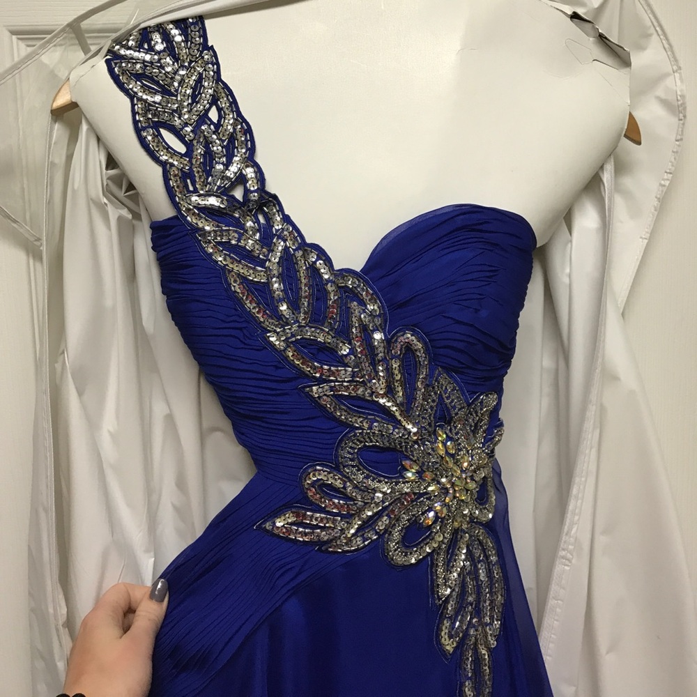 Long deep blue prom dress with cutouts and jewels