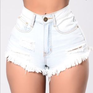 High waisted really light blue distressed shorts