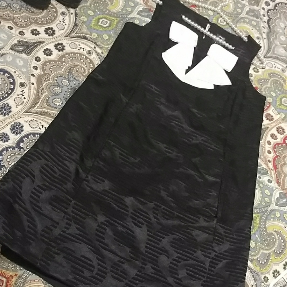 Jax black satin LBD w/classy white bow detail.