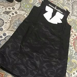 Jax black satin LBD w/classy white bow detail.