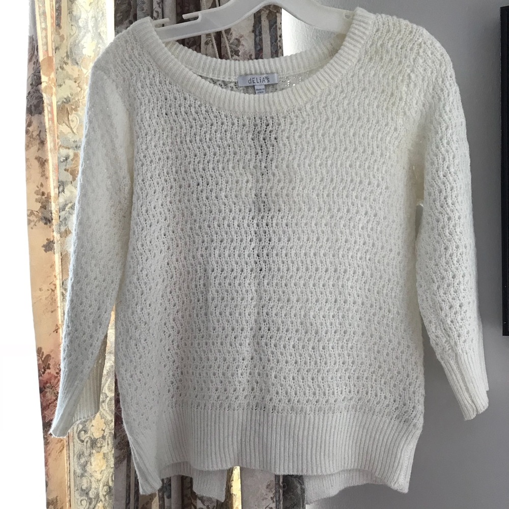 White sweater with bow detailing on back